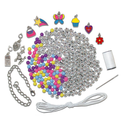 Jewelry making kit with piles of silver and colorful beads, diverse charms (butterfly, phone), a chain, string, needle, and thread