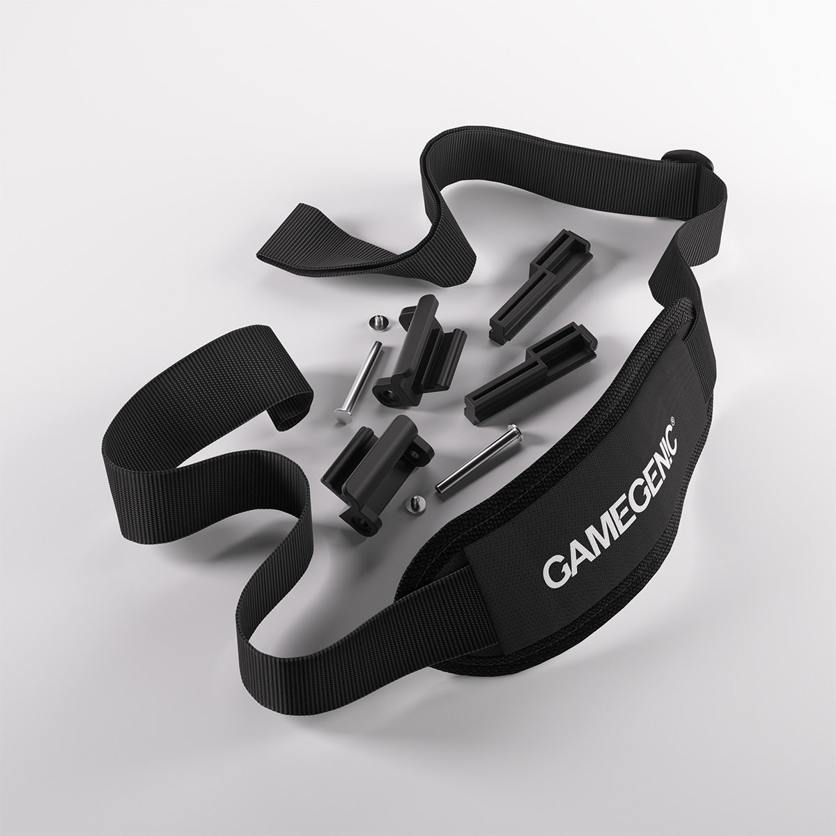 Gamegenic gaming accessory kit: black strap, four black plastic clips, two silver pins on a white surface