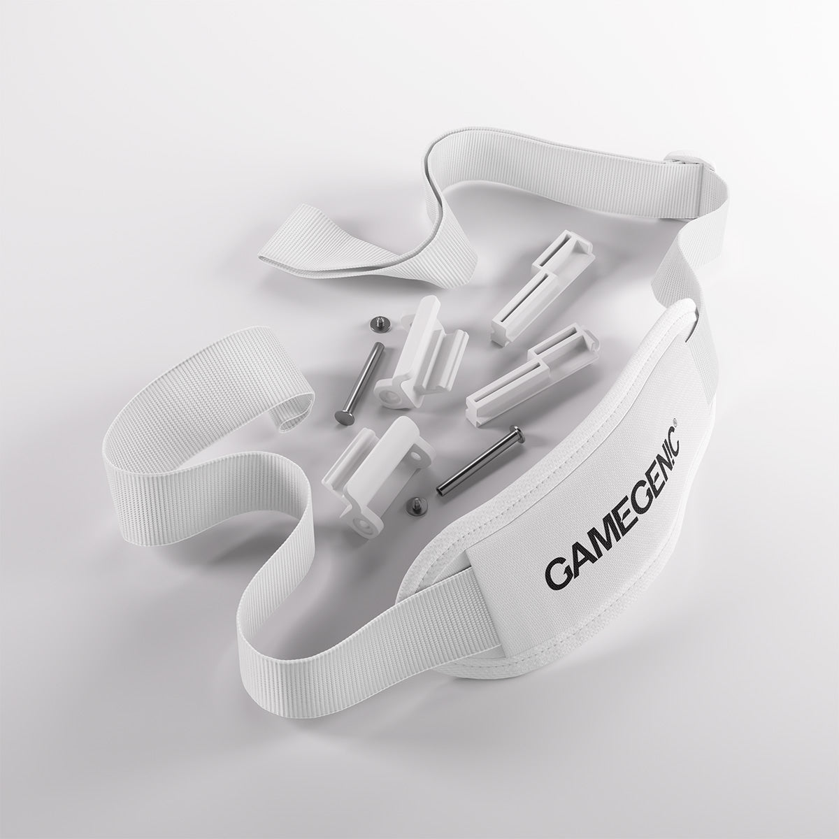 A white Gamegenic strap kit with plastic clips and metal screws laid out on a white background