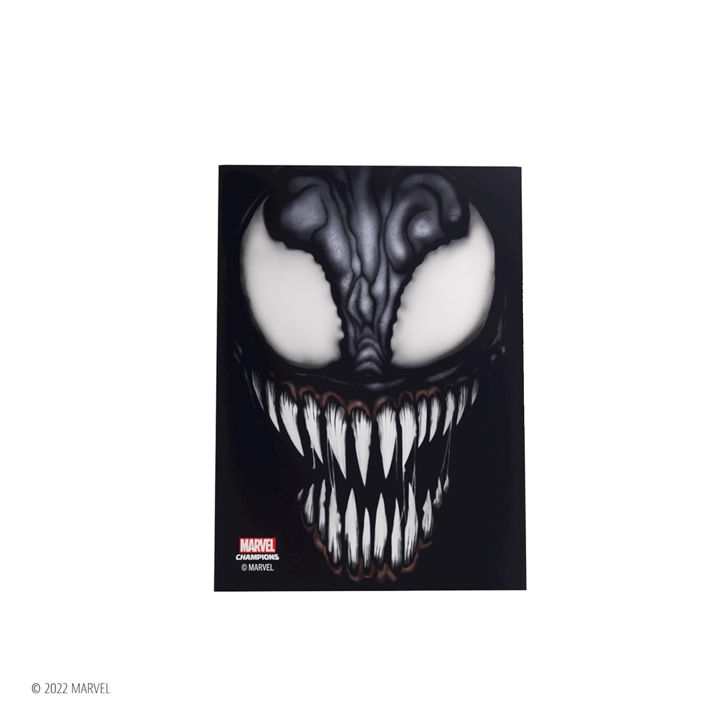 Close-up of Venom's face with large white eyes and sharp, jagged teeth