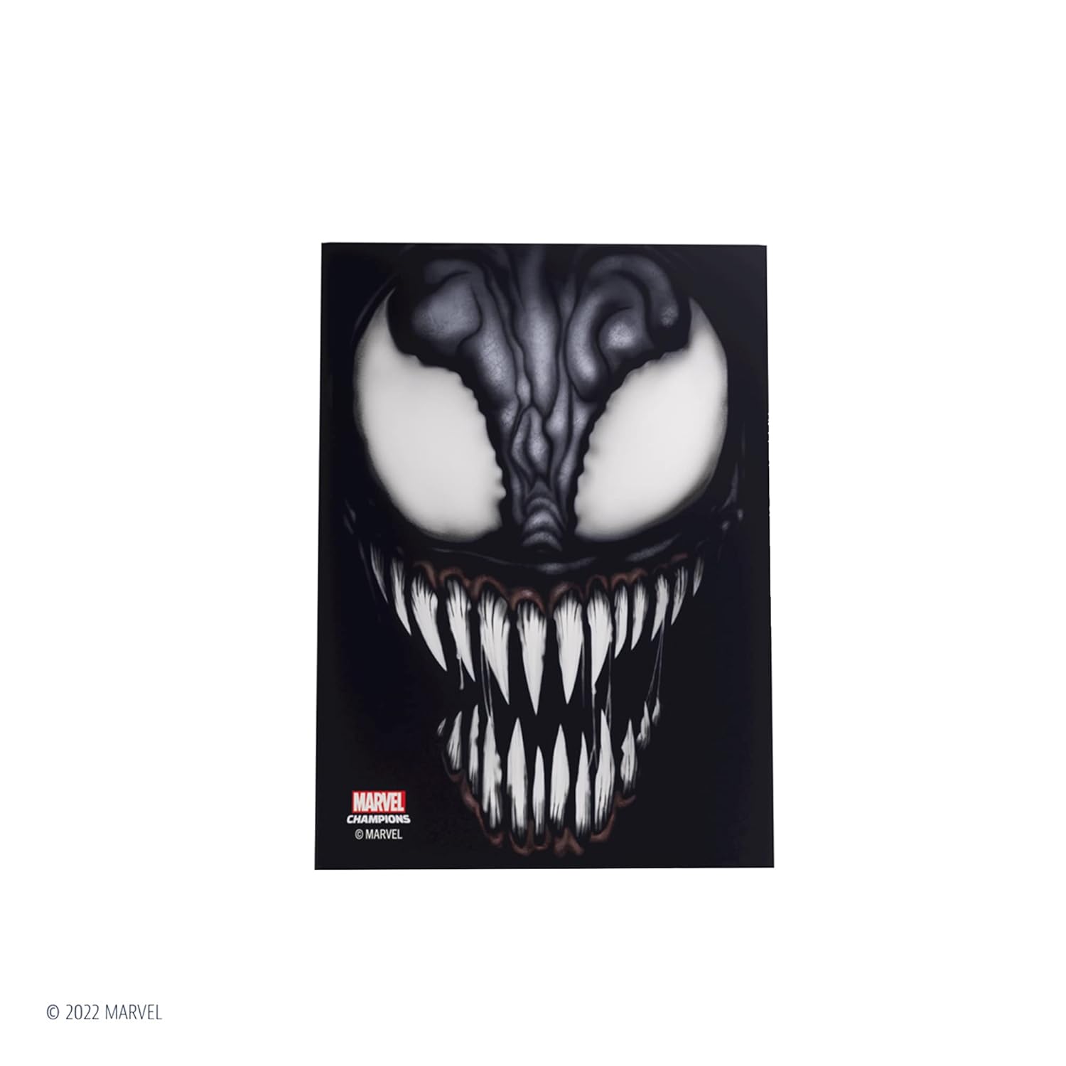 Close-up of Venom's face with large white eyes and sharp, jagged teeth