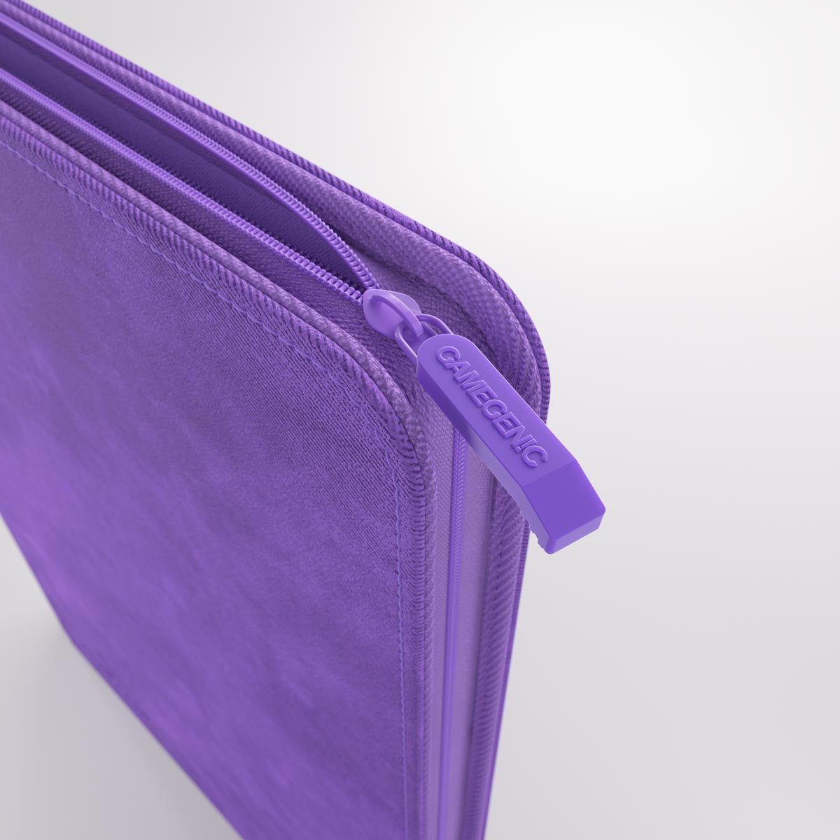 Purple fabric Gamegenic trading card Zip-Up Album edge showing a zipper and Gamegenic logo pull tab