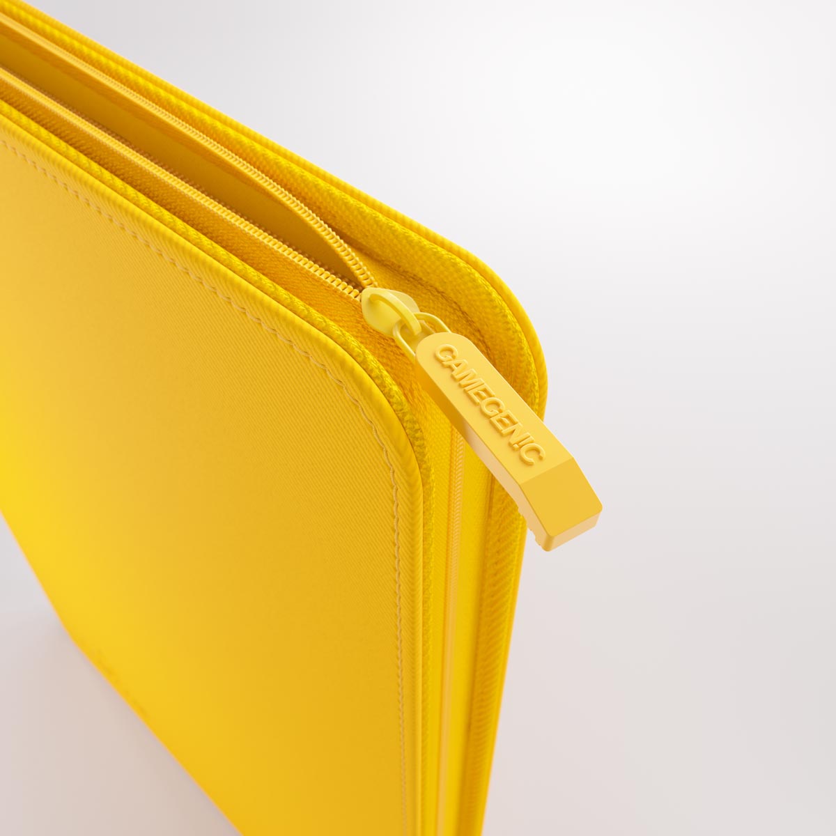 Bright yellow zippered Gamegenic trading card Zip-Up Album showing the Gamegenic logo on the zipper pull