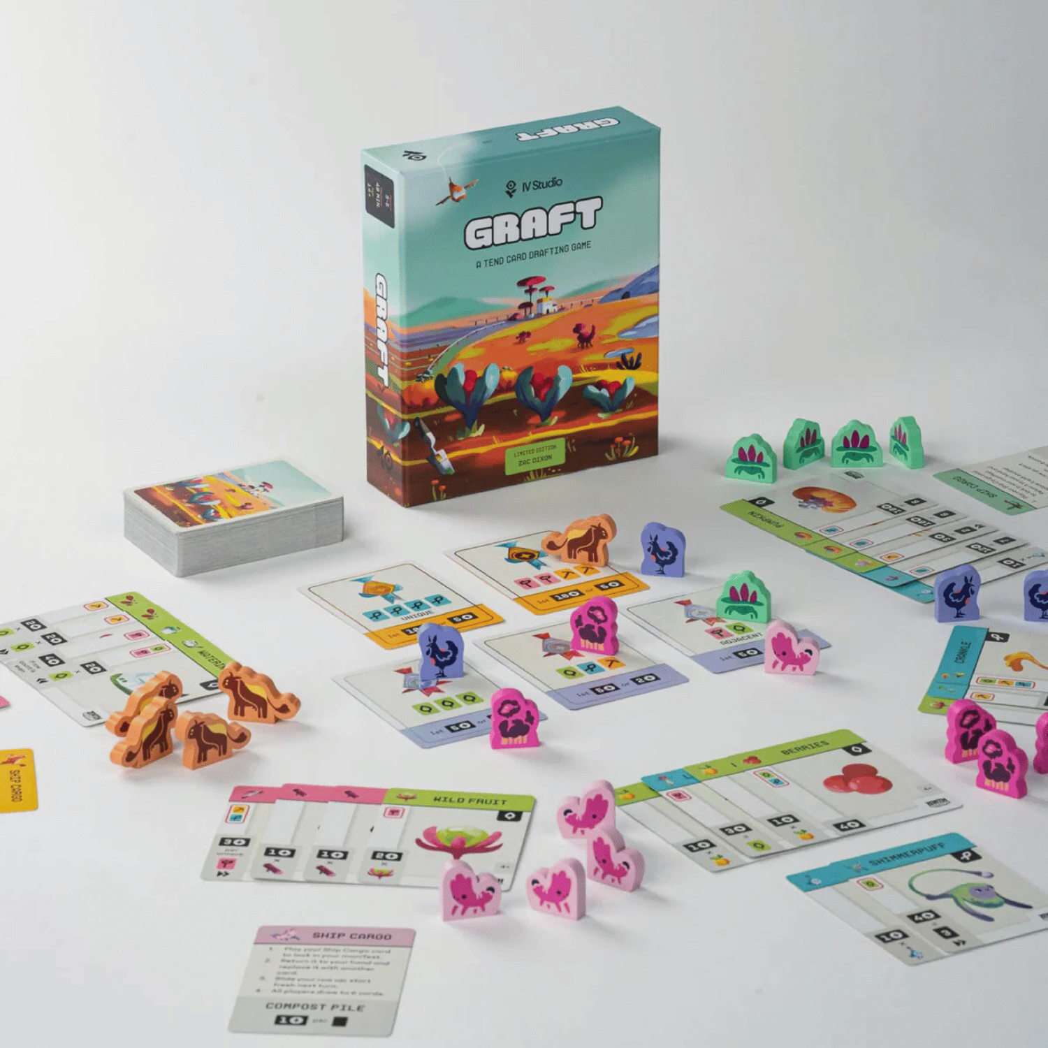 Graft card drafting game setup showing the box, component cards, and various colourful meeples/tokens
