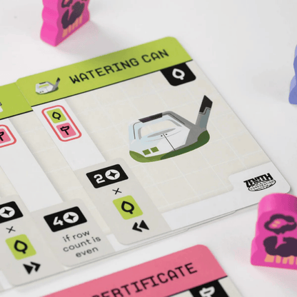 Game card titled "WATERING CAN," featuring an illustration and rules, beside pink character tokens