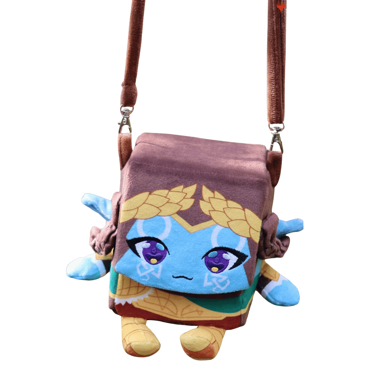 A blue, square plush Lathril ARTY Deck Box shaped like a character wearing a gold wreath, hanging from a brown strap