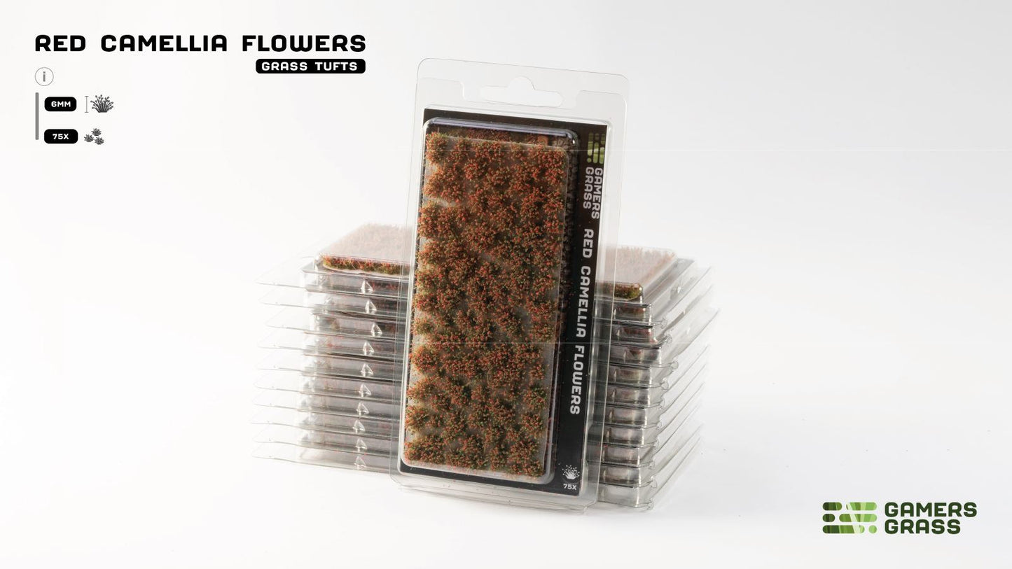 Stacked clear packages of Gamers Grass "Red Camellia Flowers" grass tufts, showing numerous small red-brown clusters