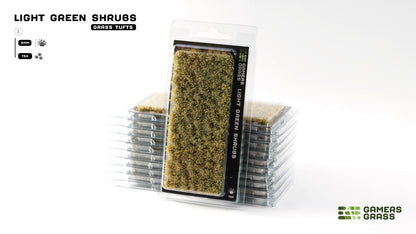 Gamers Grass Light Green Shrubs, 6mm grass tufts. One package stands upright, backed by a stack of more packs