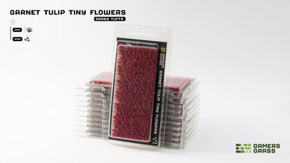 Stack of Gamers Grass 'Garnet Tulip Tiny Flowers' in clear blister packs. The 4mm deep red miniature tufts are ready for use