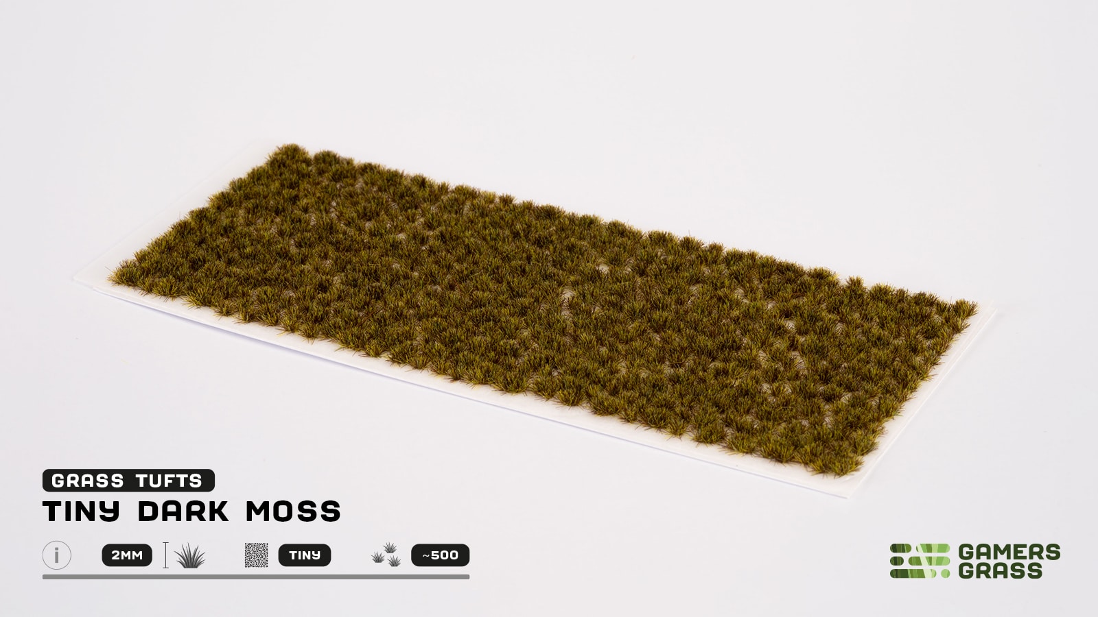 A rectangular sheet of Tiny Dark Moss model grass tufts for wargaming on a white background