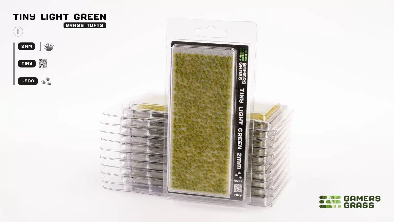 A package of Gamers Grass Tiny Light Green 2mm grass tufts stands upright, with more identical packages stacked behind