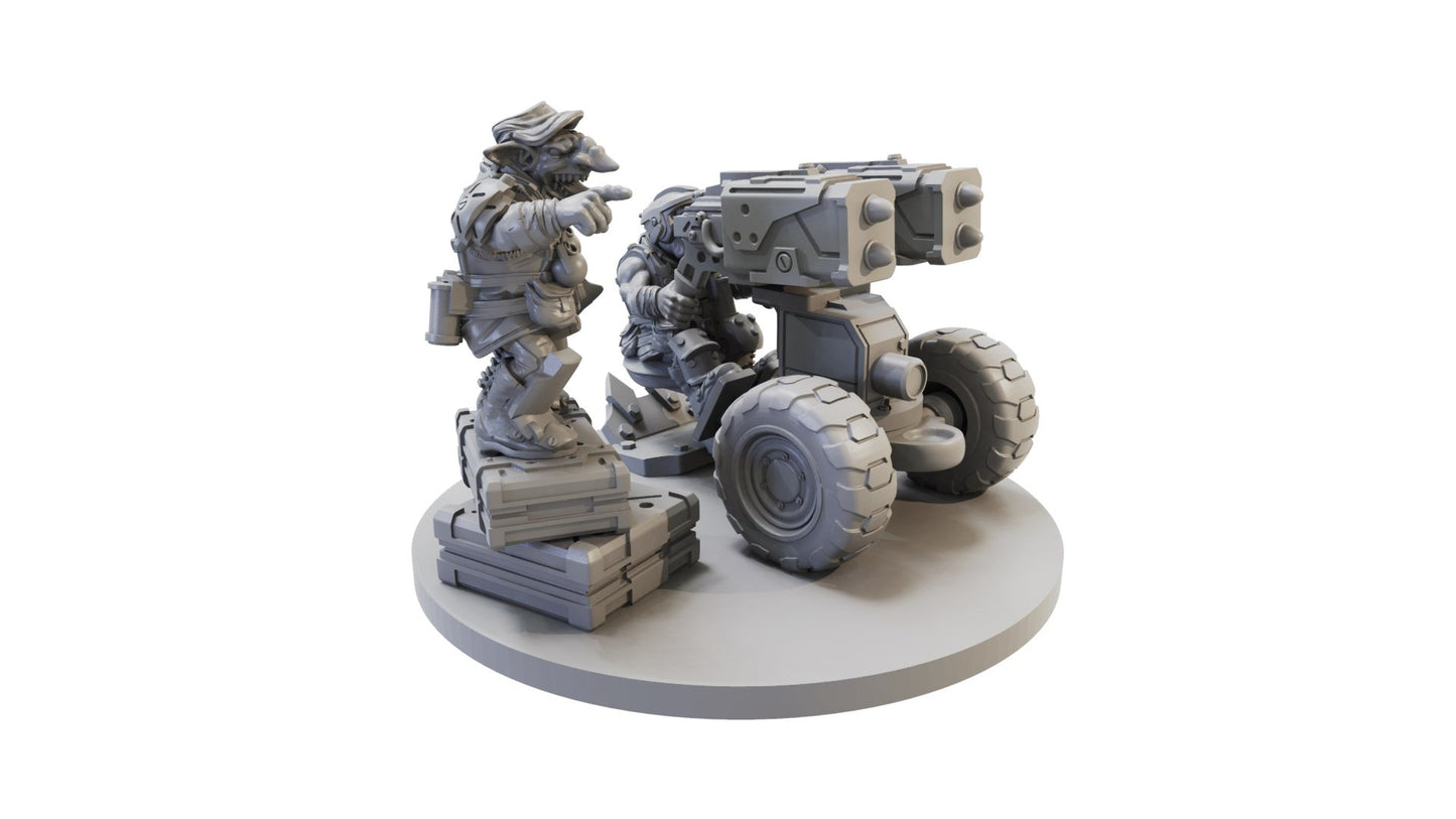 Grey wargame miniature of two goblin-like figures; one points while the other mans a wheeled rocket launcher
