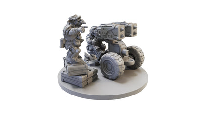 Grey wargame miniature of two goblin-like figures; one points while the other mans a wheeled rocket launcher