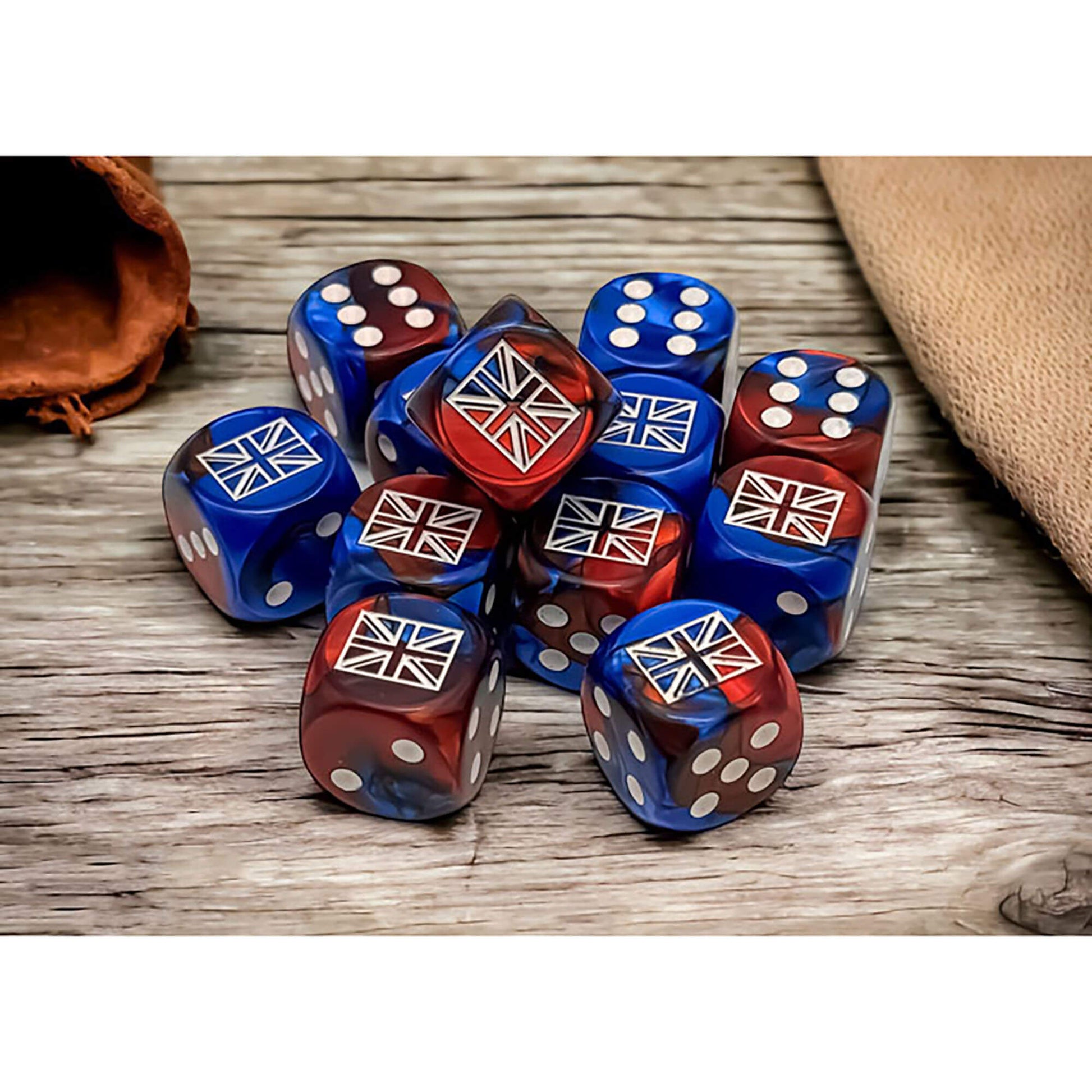 A pile of red and blue gradient dice, each displaying a white Union Jack flag, on a wooden surface
