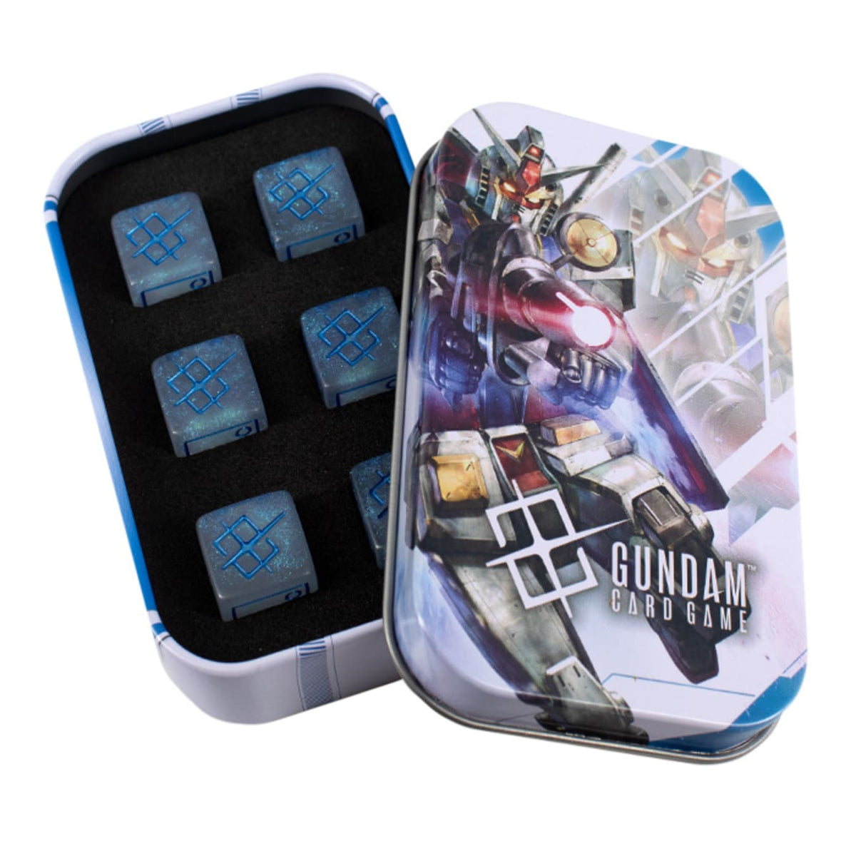 Opened Gundam Card Game tin with robot art on lid, displaying six blue symbol-etched game dice on black foam