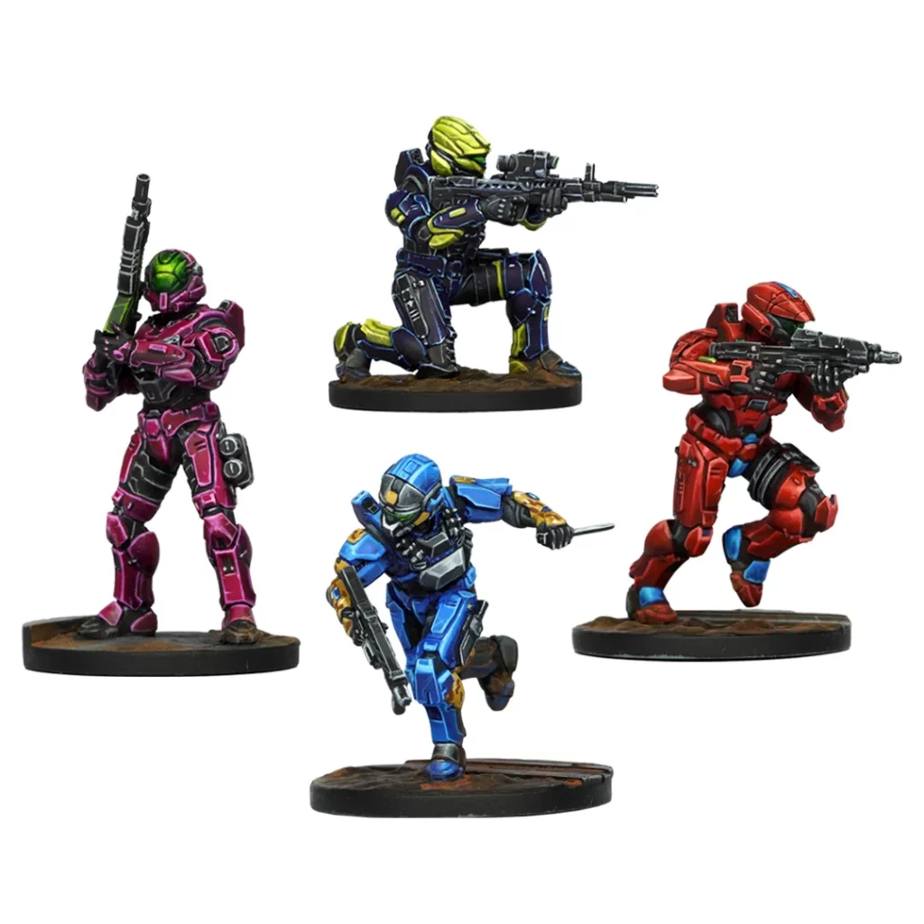 Four colorful sci-fi armored miniatures: magenta standing, blue running, red running, dark blue kneeling, all armed