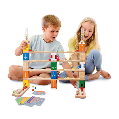 Two children excitedly play a multi-level wooden marble run toy