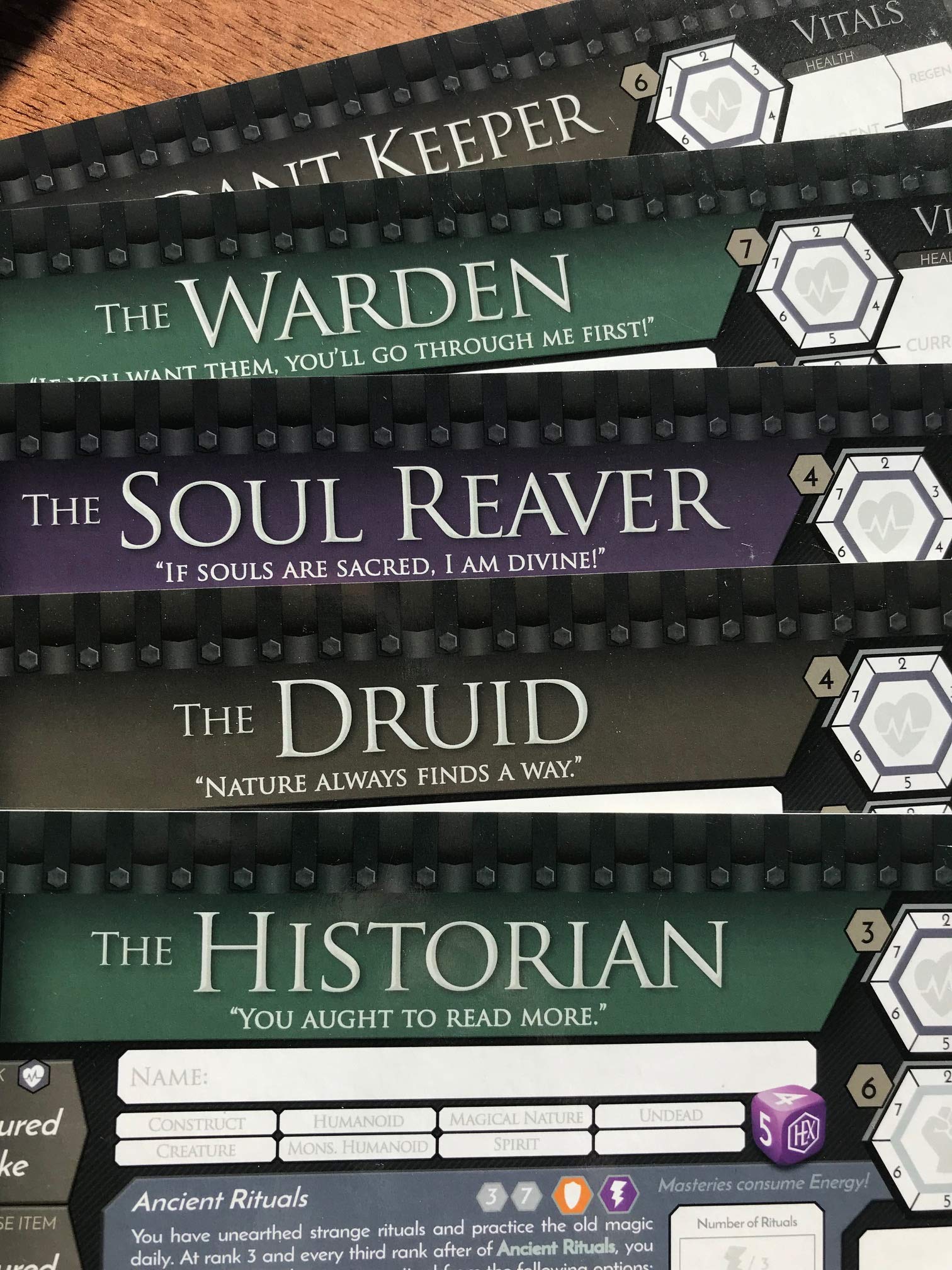 Stacked game cards featuring character names: The Warden, The Soul Reaver, The Druid, and The Historian, with game stats