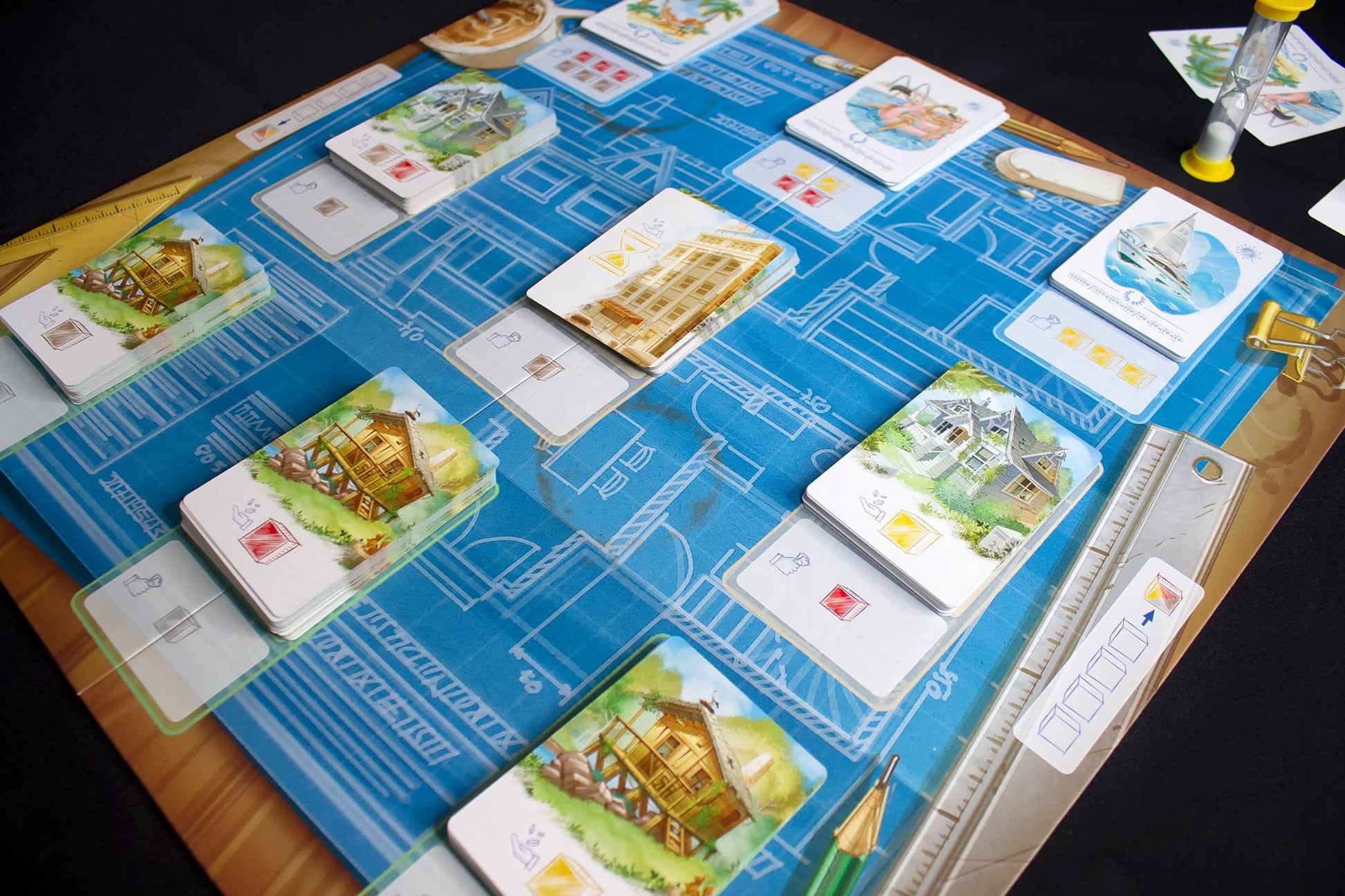 Blueprint board game with building cards and components laid out