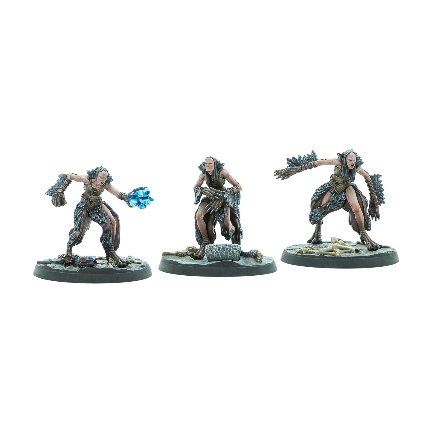 Three gaunt female miniatures in feathered attire - one casts a blue crystal spell, one crouches, one lunges snarling