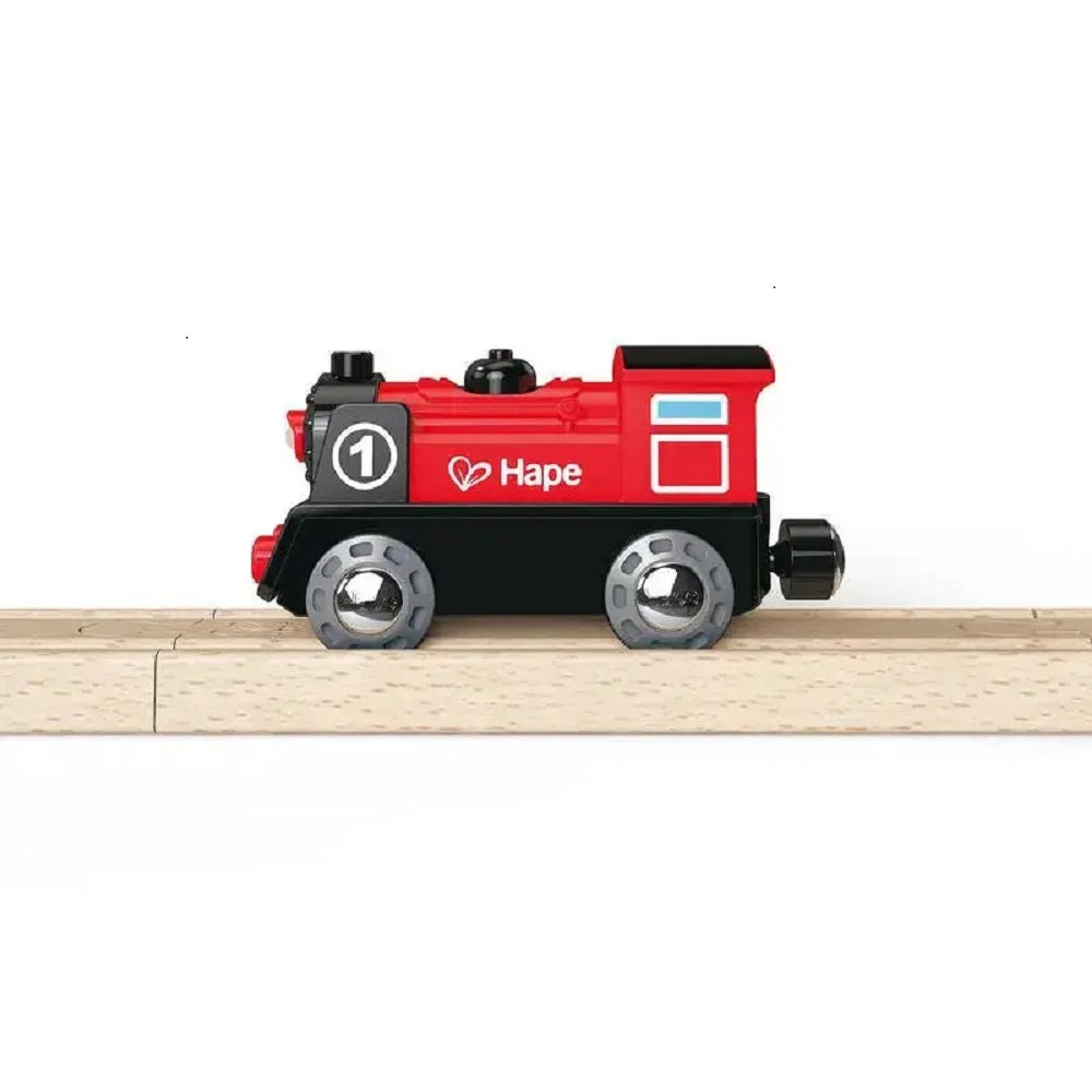 Red and black Hape toy train engine (No. 1) on a wooden track