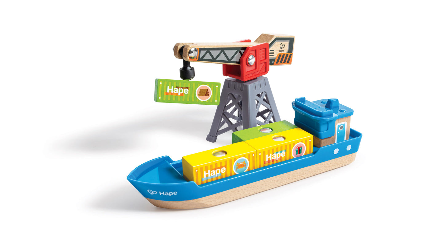 Colorful wooden toy port scene with a crane loading containers onto a blue and wood cargo ship