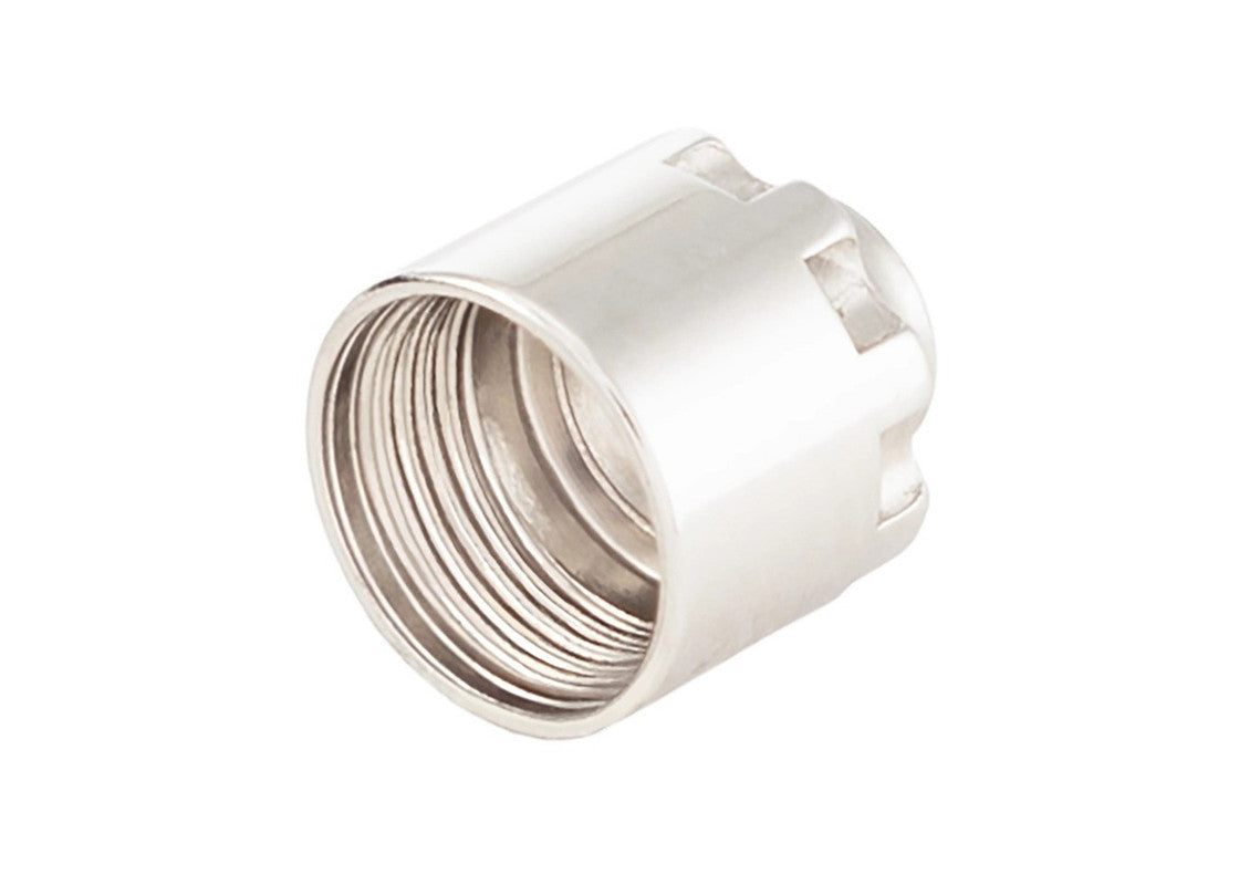 A shiny metal cylindrical needle spring retaining nut with internal threads and external notches