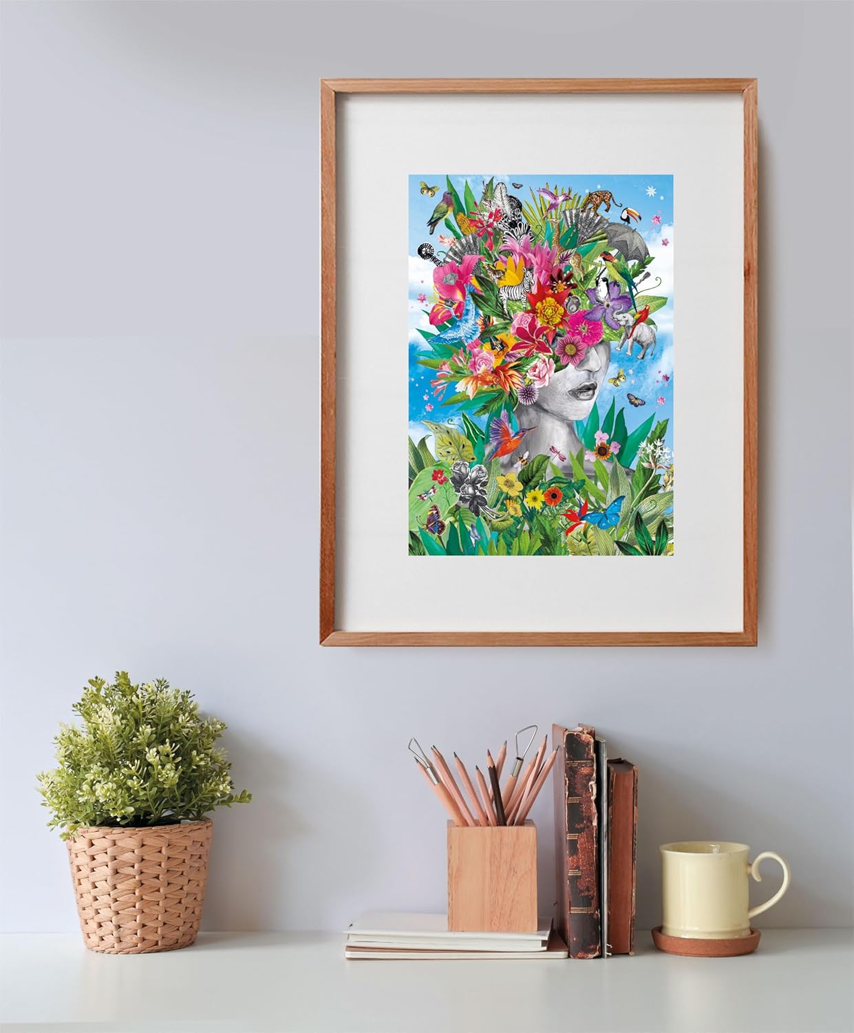 A framed collage shows a woman's face with an elaborate crown of vibrant flowers, birds, and jungle animals under a blue sky.