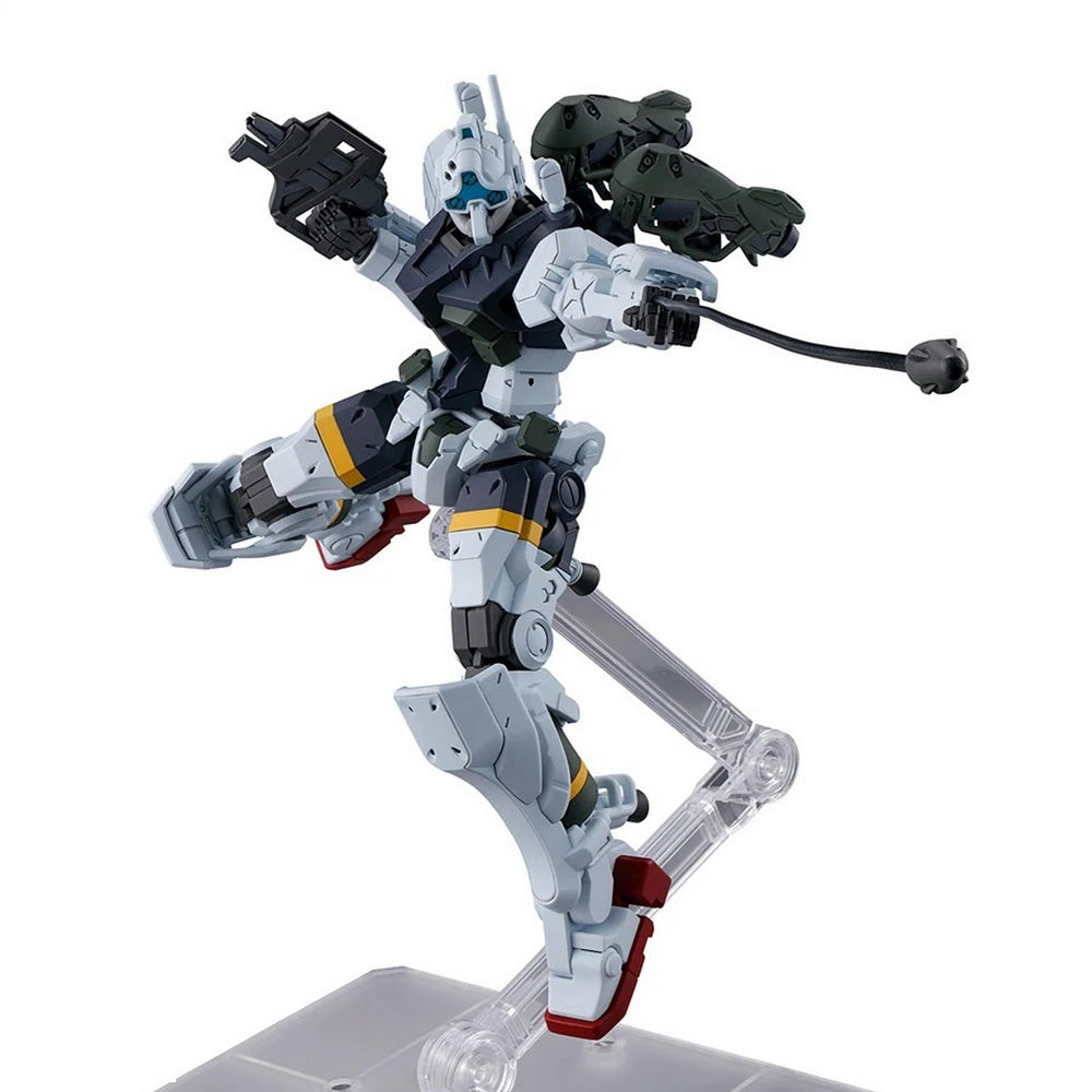 Light and dark gray robot model in a kicking pose, holding a black rifle and a wired weapon, on a clear stand