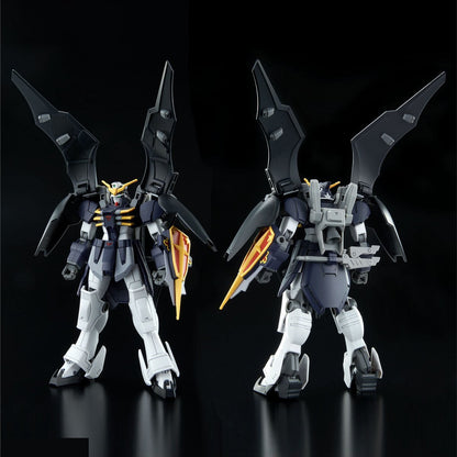 Front and back views of a dark blue & white winged Gundam model with large black wings and a blade shield