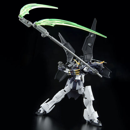 A winged dark Gundam model in a dynamic pose, holding a long staff with two glowing green scythe blades