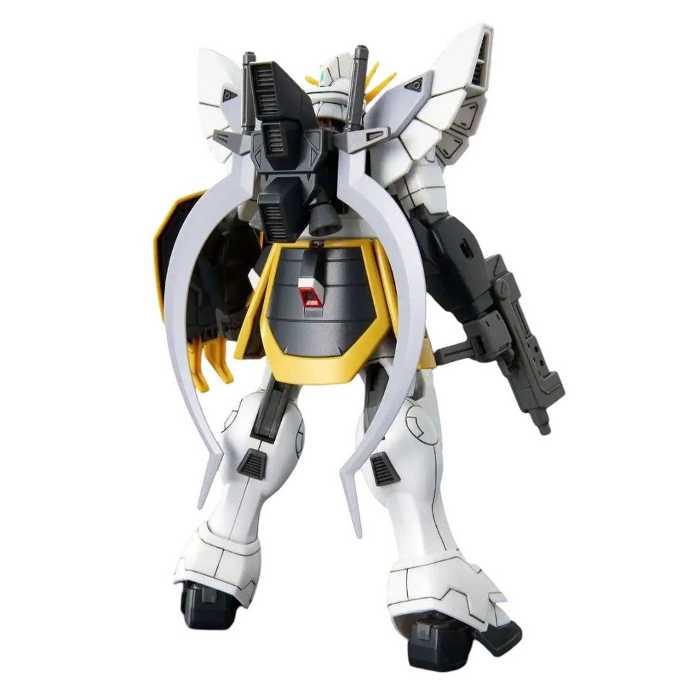 White, black, and yellow Gundam model, seen from behind, with large wings, curved back weapons, and a rifle