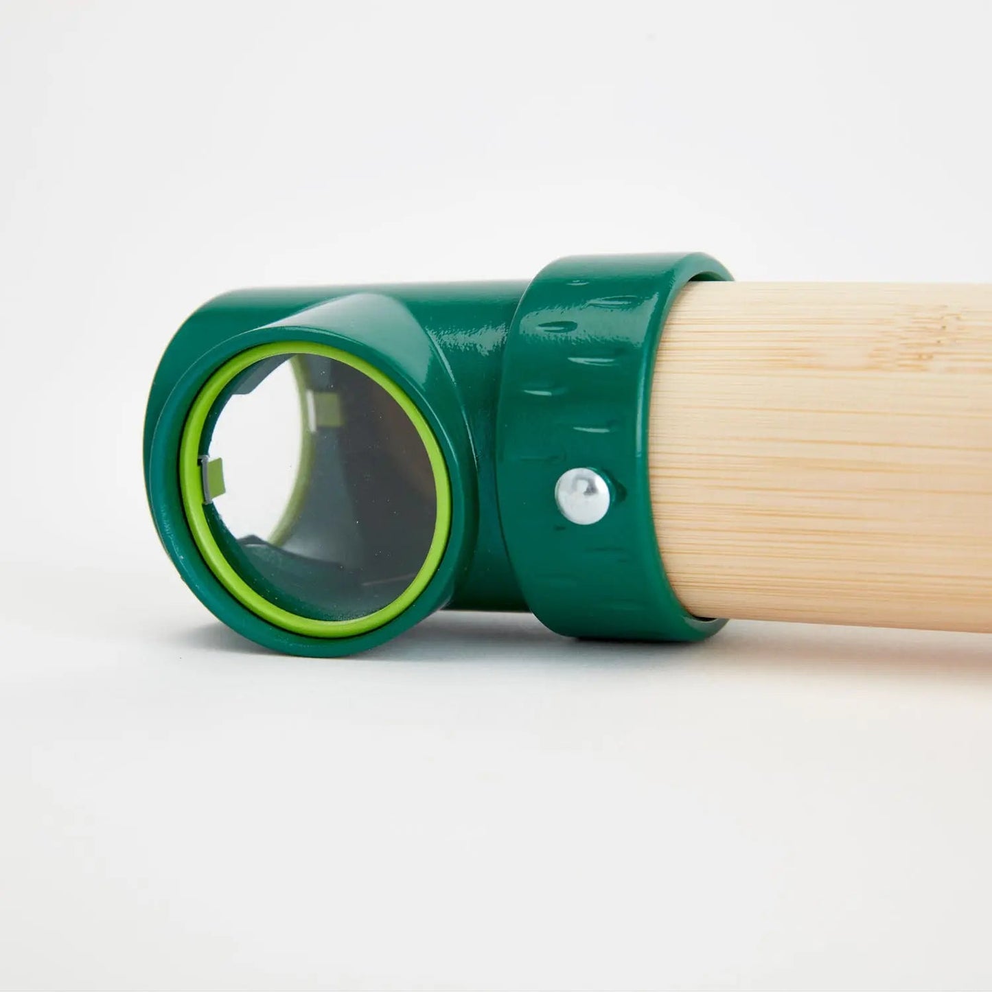 Dark green plastic fitting attached to a light wood pole, showing a clear viewport with a bright green ring