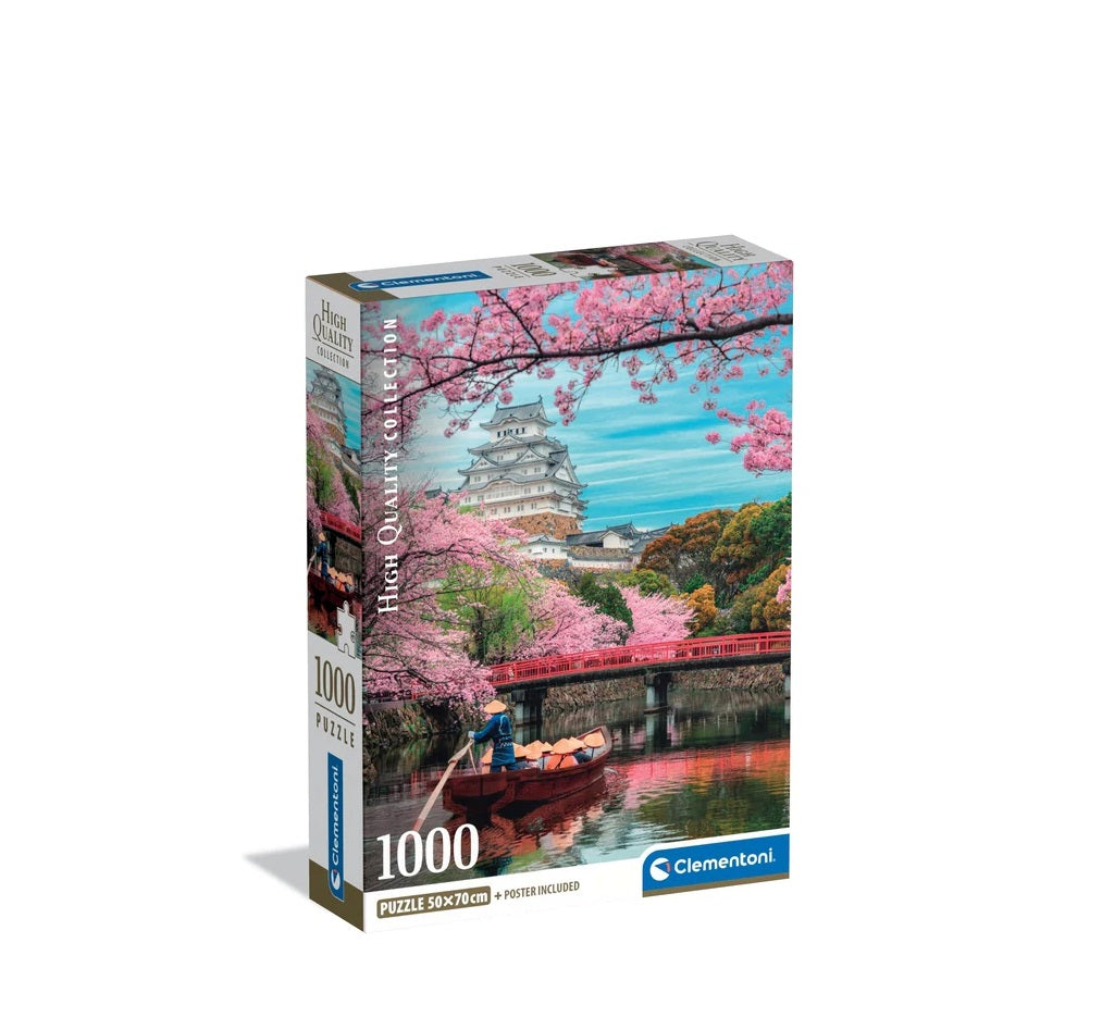 Puzzle box featuring a Japanese castle, pink cherry blossoms, a red bridge, and a person rowing a boat.