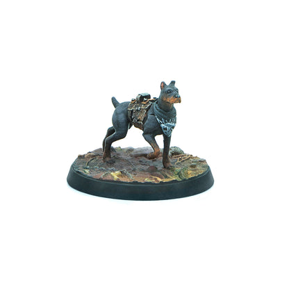 Dark grey miniature dog with a saddle pack and skull bandana, striding on a detailed terrain base