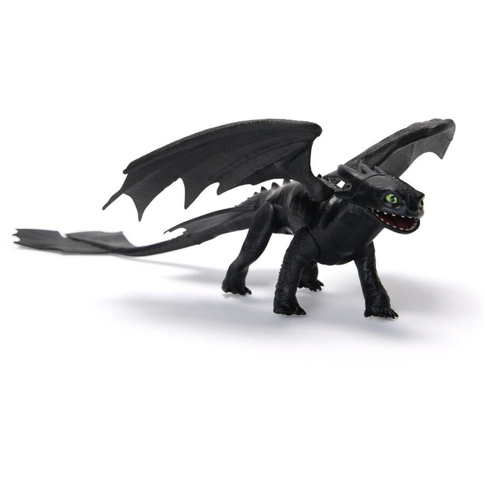 Black Toothless dragon toy with large wings, green eyes, and long tail, standing on a white background