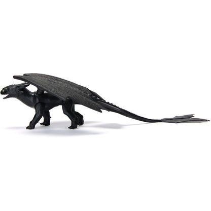 Black Toothless dragon action figure with prominent wings, green eyes, and a long tail, standing in profile on a white background