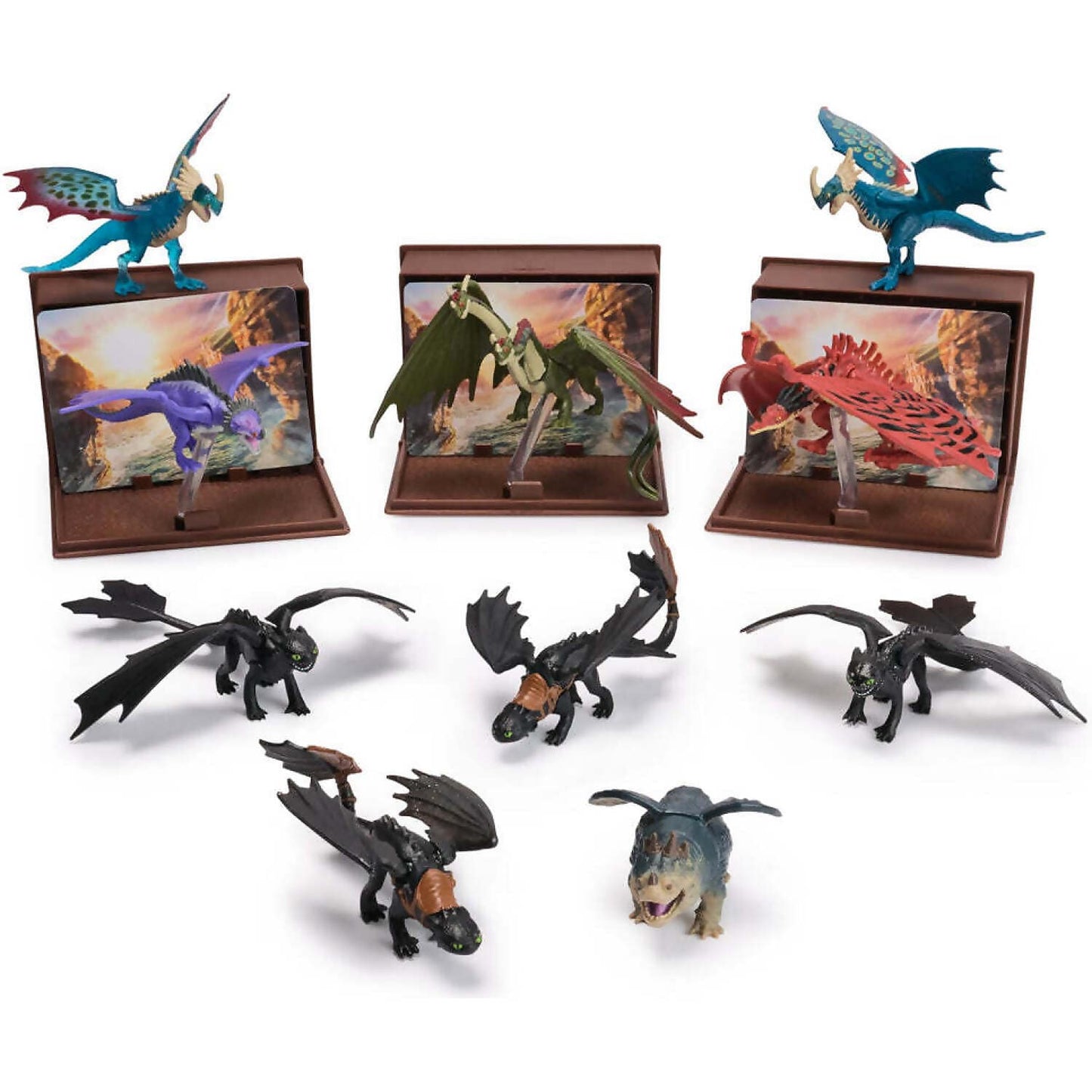 Eleven How to Train Your Dragon toy figures, including Toothless, Stormfly, Hookfang, Meatlug, Light Fury, and Rumblehorn, three are on display stands with scenic backgrounds