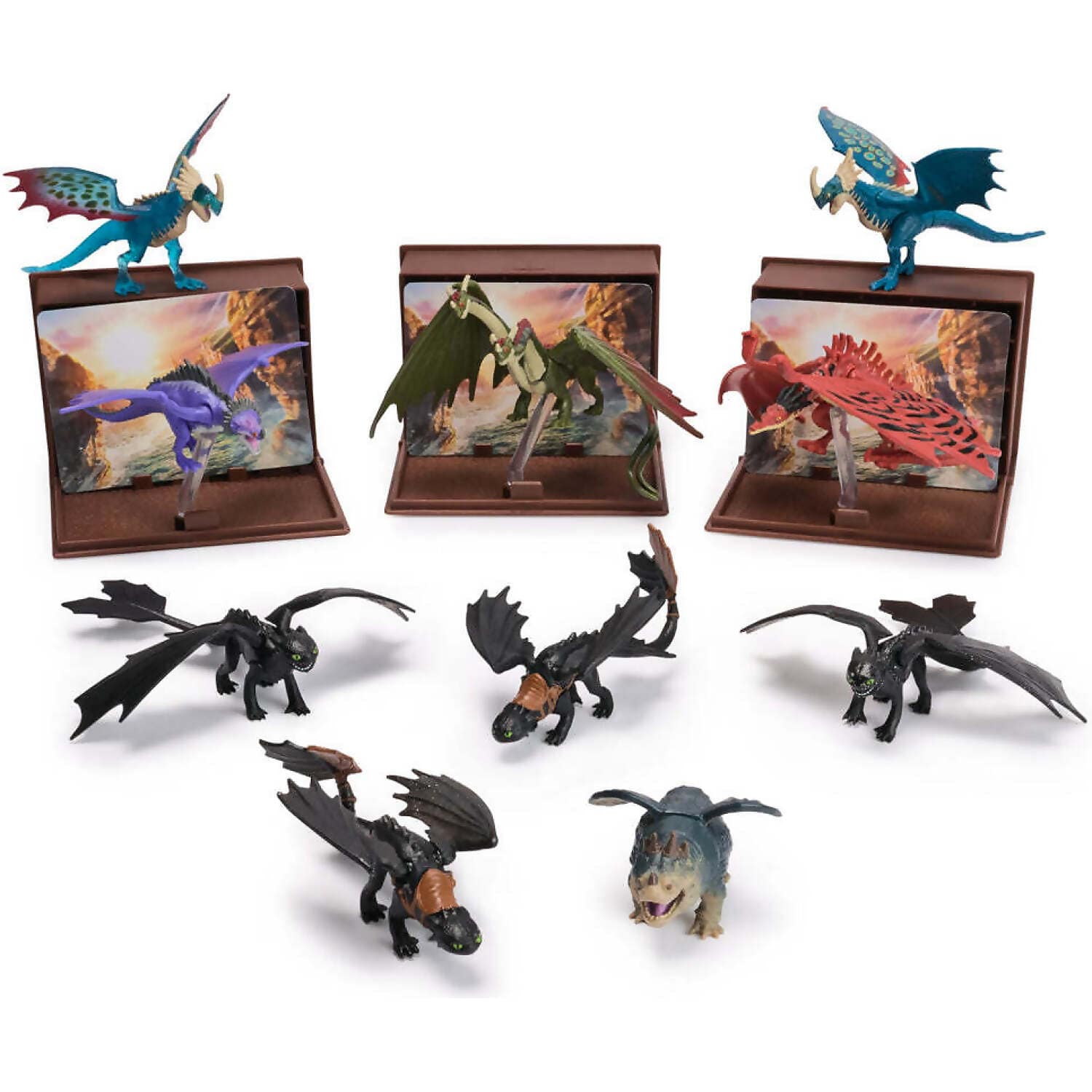 Eleven How to Train Your Dragon toy figures, including Toothless, Stormfly, Hookfang, Meatlug, Light Fury, and Rumblehorn, three are on display stands with scenic backgrounds