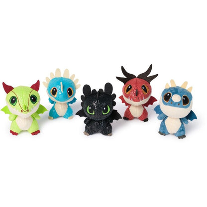 Five dragon plush toys: green, light blue, black (Toothless), red, and blue