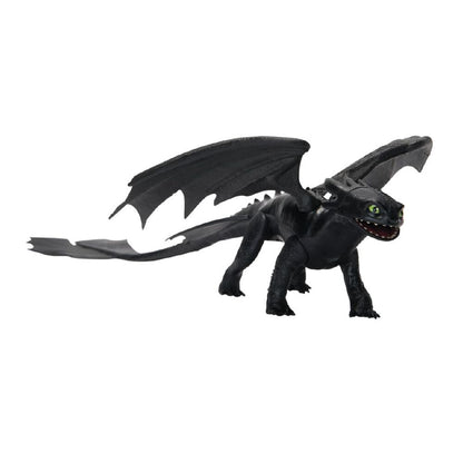 Black Toothless dragon toy with large wings, green eyes, and long tail, standing on a white background