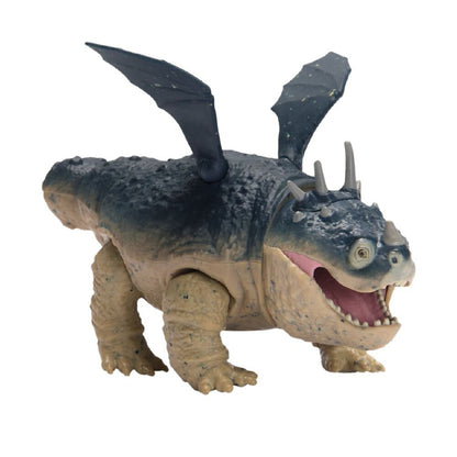 Dragon toy with dark blue scaly back, tan belly, small wings, horns, and open mouth with pink interior, standing on a white background