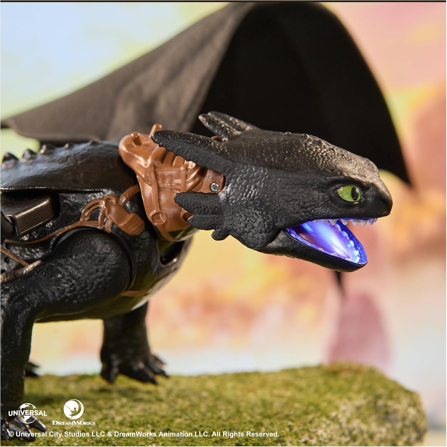Toothless dragon figure with glowing blue mouth, vivid green eyes, and brown saddle, standing on moss with black wings visible