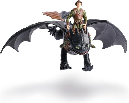 How to Train Your Dragon Hiccup action figure riding a black Toothless dragon with wide wings and green eyes