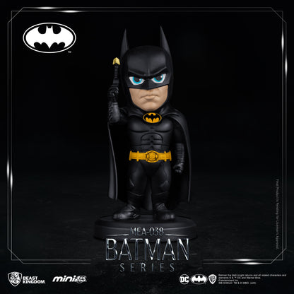 Close-up of Batman figure with armored suit and cape, standing on circular base