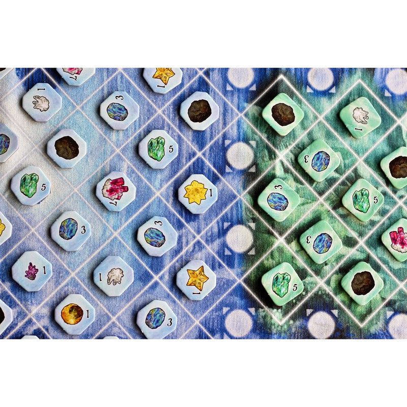 Tiles from the Sir Ocelot&#39;s Cave board game featuring various resource types and numbers