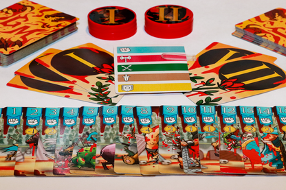 A board game laid out: cards depicting cartoon combat with blood, numbered cards, red Roman numeral tokens, and a reference card