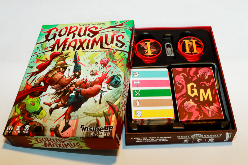 An open "Gorus Maximus" board game box, displaying gory cover art, game cards, and red numbered tokens