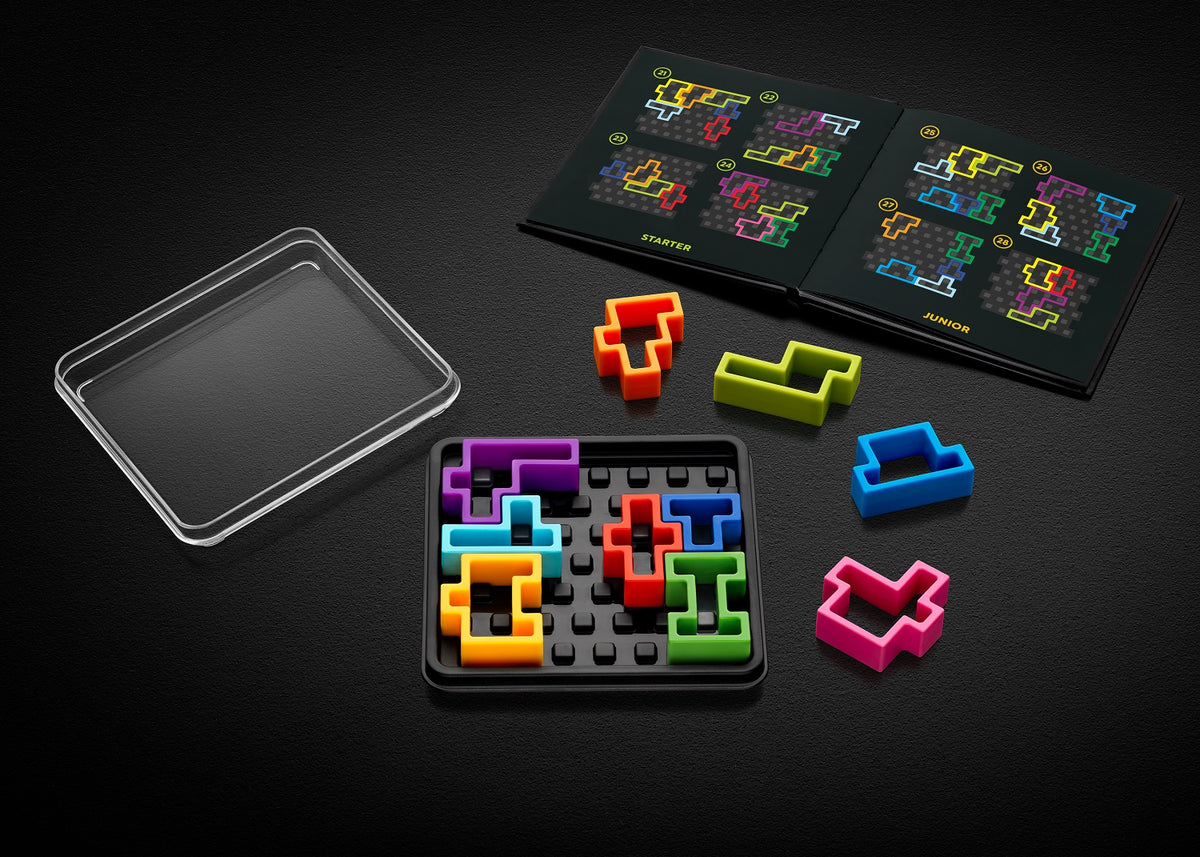 IQ Deluxe Square logic puzzle with colorful geometric pieces placed in a black grid tray and an open challenge booklet