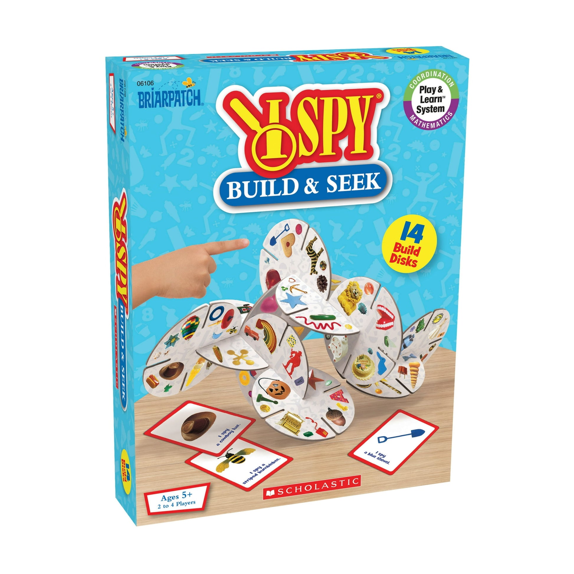 I SPY Build & Seek game box. A child's hand points to interconnected 'Build Disks' covered in hidden items, plus 'I Spy' cards